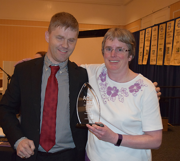 Eric Bridges with Sharon Lovering holding recognition award