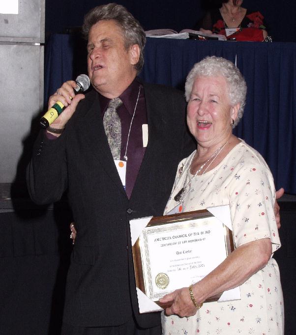 Paul Edwards presents Dot Taylor with her life membership certificate.