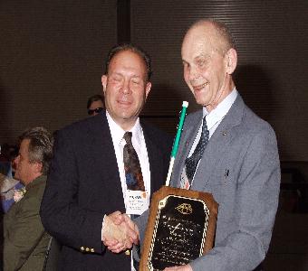 Michael Richman presents John Taylor of Iowa with the George Card Award.