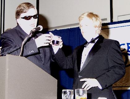 No hard feelings: Brian Charlson and Chris Gray clink their glasses in a toast
at the banquet Friday night.