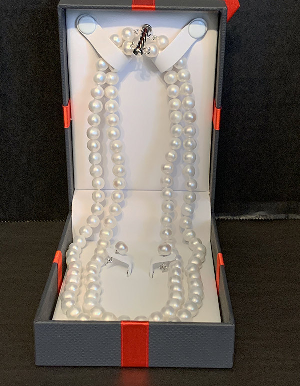 Pearl necklace in a black box with red trim
