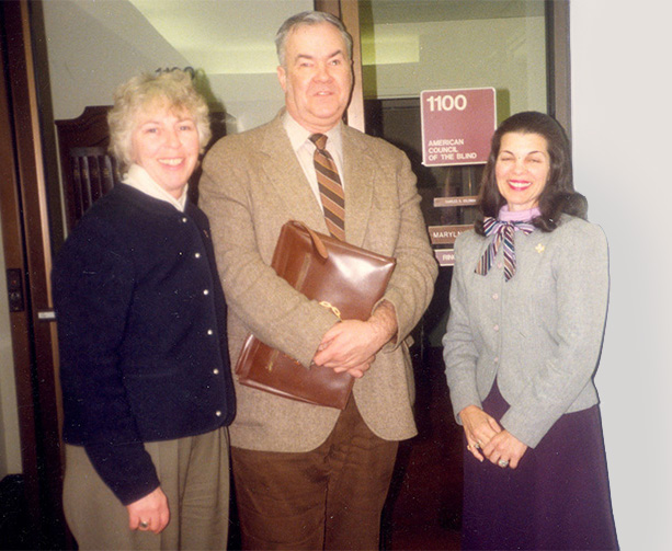 Roberta Douglas, Oral Miller, and Margarine Beaman stand in front of the Vermont Avenue office (suite 1100), circa 1986. 