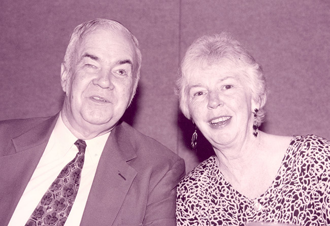 Oral Miller and Roberta Douglas, seated at the head table during ACB’s 1998 convention banquet, enjoy light conversation between the presentations.
